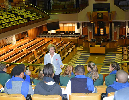 The Overstrand JTC listen with interest as Mayor Nicolette Botha-Guthrie explains that the Western Cape House of Parliament has sittings in the Chambers on matters concerning legislation of the province, is a forum for public debate, as well as being the body that oversees the Executive (government) and holds the government to account.